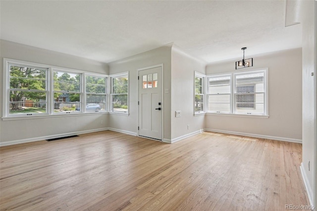2709 S Franklin St, Denver, CO 80210 - foyer with light wood-type flooring and a chandelier