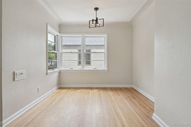2709 S Franklin St, Denver, CO 80210 - spare room with wood finished floors, a chandelier, and a textured wall