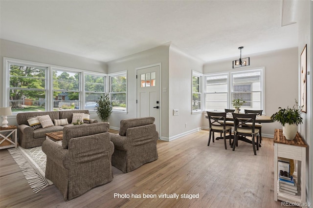 2709 S Franklin St, Denver, CO 80210 - living area with light wood-style floors, healthy amount of natural light, and a chandelier
