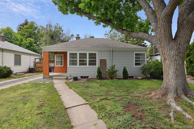 2709 S Franklin St, Denver, CO 80210 - view of front facade with a front lawn, a shingled roof, and a chimney