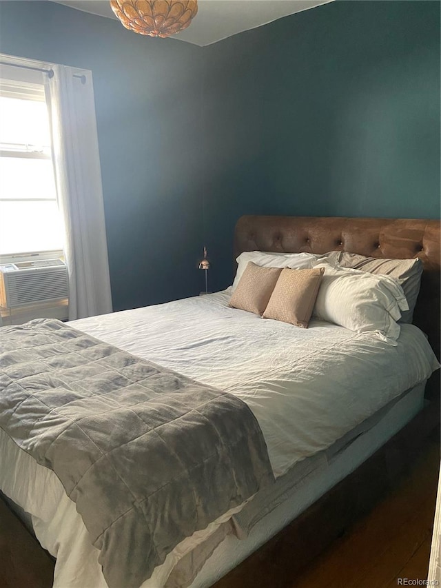 bedroom featuring hardwood / wood-style floors and cooling unit