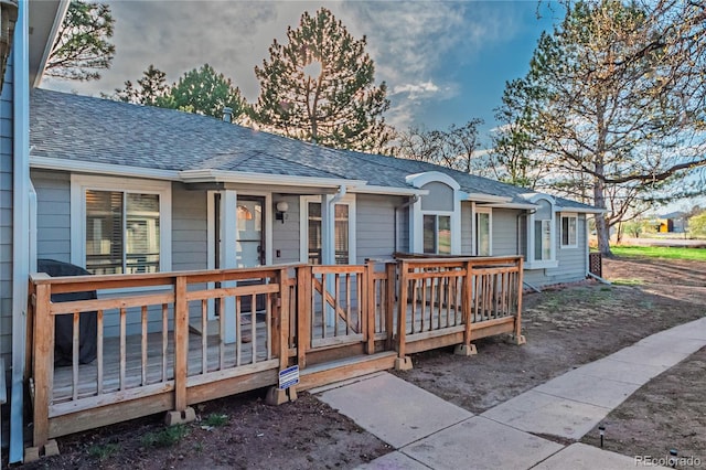 7945 York St Unit 2, Denver, CO 80229 - view of front of property featuring roof with shingles and a wooden deck
