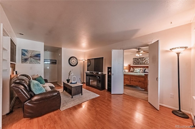 7945 York St Unit 2, Denver, CO 80229 - living area featuring a fireplace, light wood-type flooring, and ceiling fan