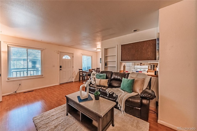 7945 York St Unit 2, Denver, CO 80229 - living room featuring wood finished floors and built in shelves