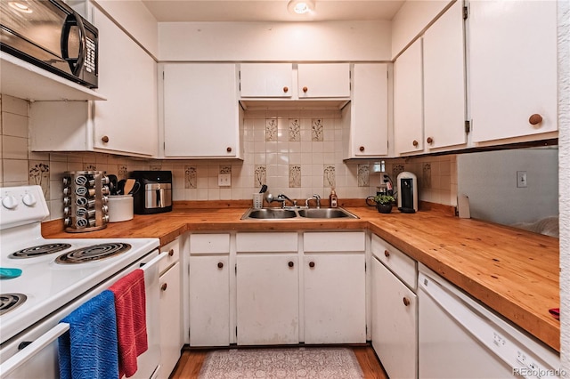 7945 York St Unit 2, Denver, CO 80229 - kitchen featuring white appliances, decorative backsplash, white cabinetry, and butcher block countertops