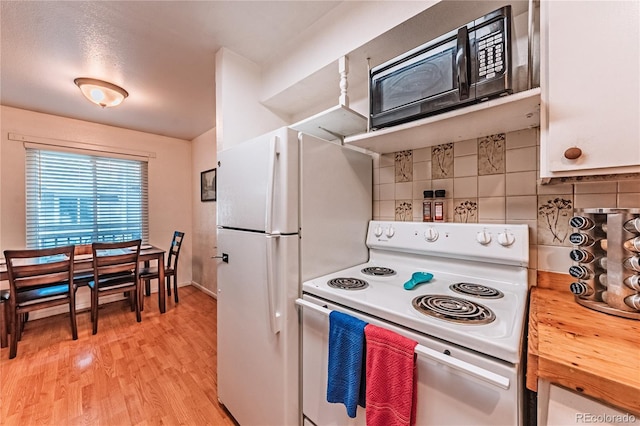 7945 York St Unit 2, Denver, CO 80229 - kitchen with white appliances, butcher block counters, light wood-style floors, and tasteful backsplash