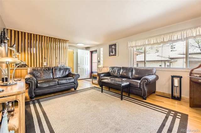 living room featuring baseboards and light wood finished floors