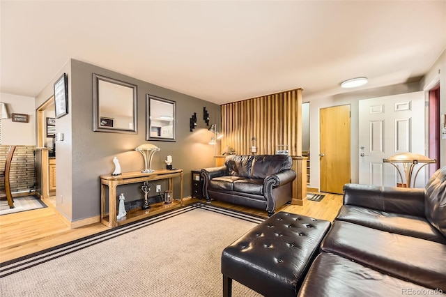 living room with baseboards and light wood-type flooring