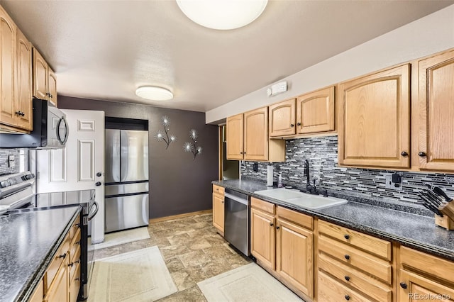 kitchen with a sink, decorative backsplash, dark countertops, and stainless steel appliances
