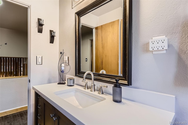 bathroom with vanity and wood finished floors