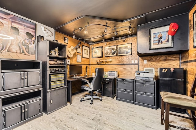 office area featuring wood walls and light wood-style floors