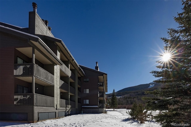 snow covered property featuring a mountain view