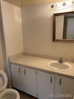 bathroom featuring vanity and toilet