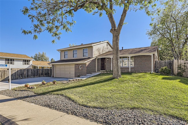 split level home with a garage, brick siding, fence, driveway, and a front yard