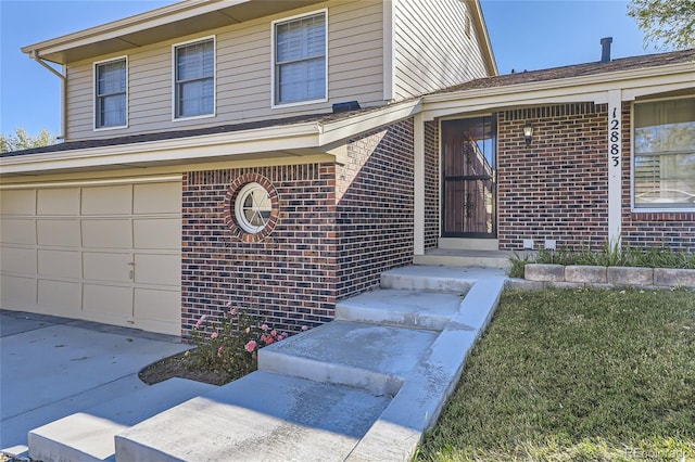 view of front of home with an attached garage, concrete driveway, and brick siding