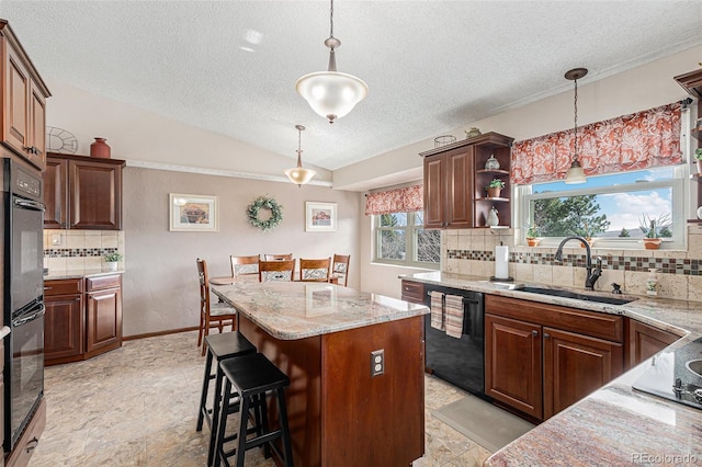1095 Lake Woodmoor Dr, Monument, CO 80132 - kitchen with black appliances, a sink, a textured ceiling, a center island, and tasteful backsplash