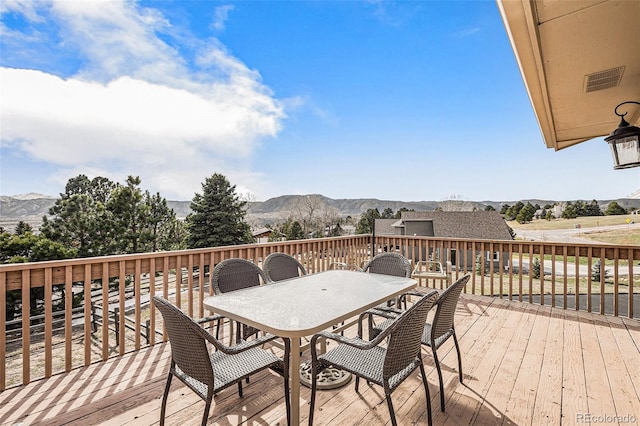 1095 Lake Woodmoor Dr, Monument, CO 80132 - wooden deck with outdoor dining area and a mountain view