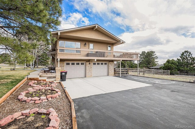 1095 Lake Woodmoor Dr, Monument, CO 80132 - view of front of house with asphalt driveway, stucco siding, brick siding, and an attached garage