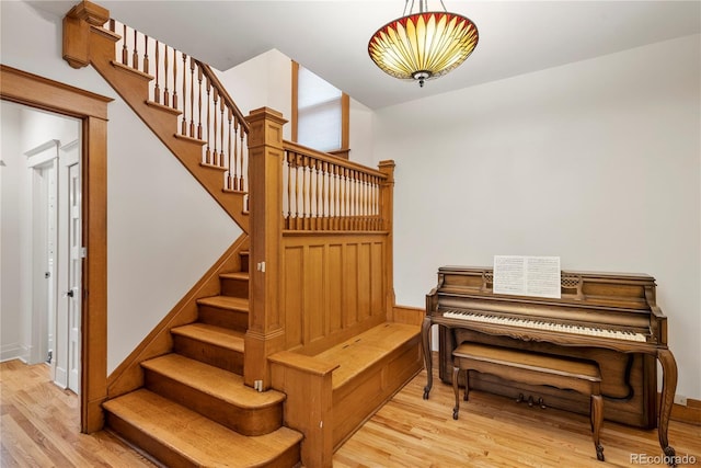 staircase with hardwood / wood-style flooring