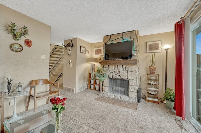 14034 E Utah Cir, Aurora, CO 80012 - living room with stairway, a stone fireplace, carpet, and a textured ceiling
