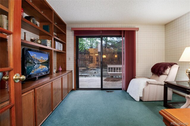 7500 E Dartmouth Ave Unit 16, Denver, CO 80231 - living area featuring carpet, a textured ceiling, and wallpapered walls