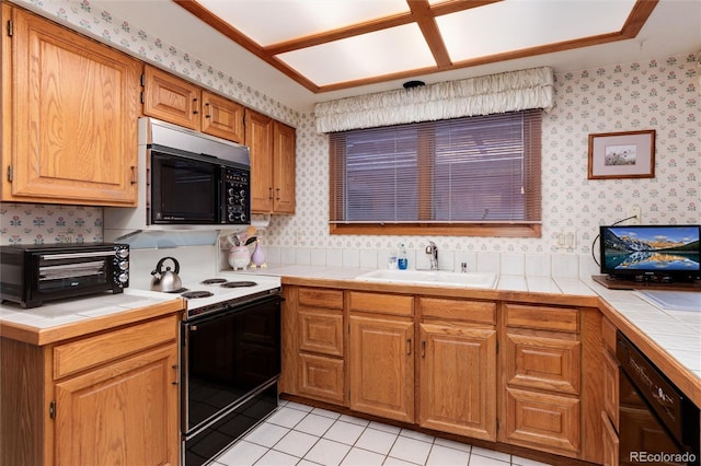 7500 E Dartmouth Ave Unit 16, Denver, CO 80231 - kitchen featuring black appliances, a sink, tile countertops, wallpapered walls, and light tile patterned flooring