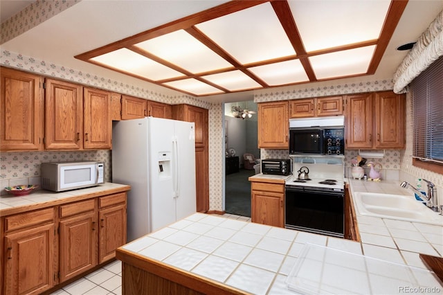 7500 E Dartmouth Ave Unit 16, Denver, CO 80231 - kitchen with white appliances, wallpapered walls, tile countertops, a sink, and a peninsula