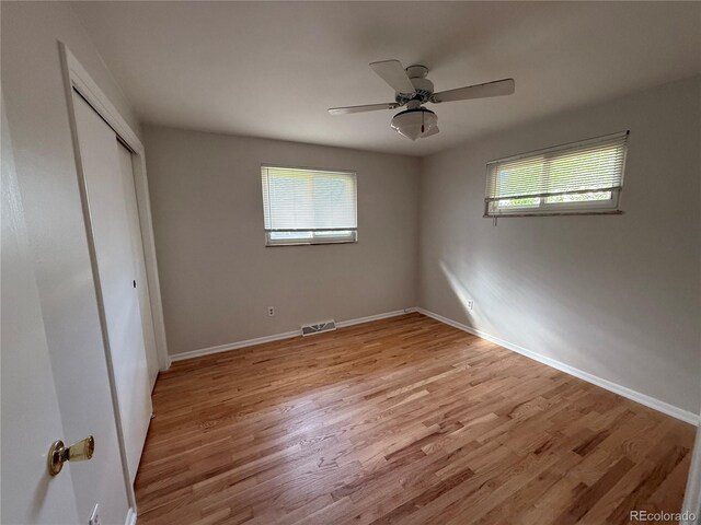 2991 S Whiting Way, Denver, CO 80231 - unfurnished bedroom with light wood-style flooring, a closet, and baseboards