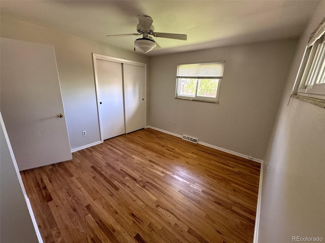 2991 S Whiting Way, Denver, CO 80231 - unfurnished bedroom with wood finished floors, baseboards, a closet, and ceiling fan