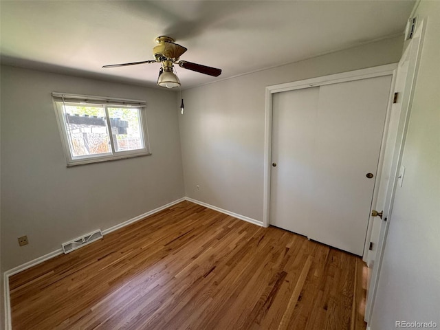 2991 S Whiting Way, Denver, CO 80231 - unfurnished bedroom featuring wood finished floors, a closet, baseboards, and ceiling fan