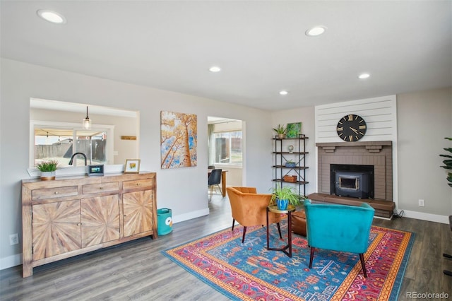 living room featuring baseboards, wood finished floors, and recessed lighting