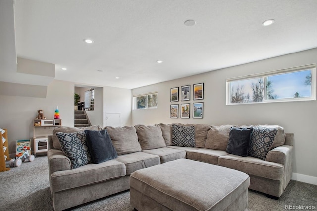 living room featuring baseboards, recessed lighting, and light colored carpet