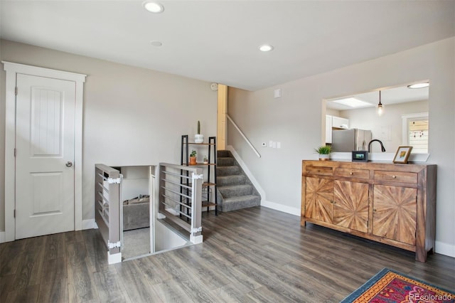 interior space featuring baseboards, wood finished floors, and recessed lighting