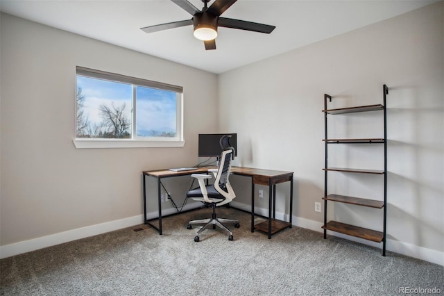 office space with baseboards, carpet flooring, and a ceiling fan