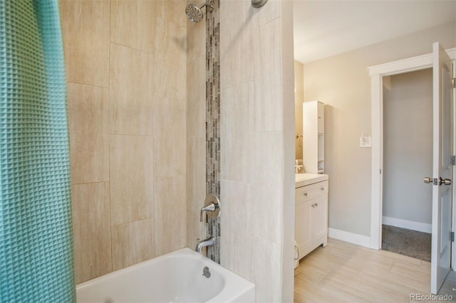 full bath featuring vanity, baseboards, and shower / bathtub combination with curtain