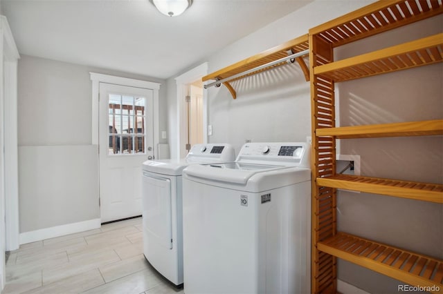 laundry area featuring independent washer and dryer, baseboards, and laundry area