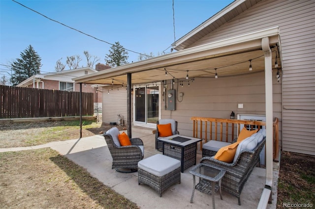 view of patio / terrace featuring an outdoor fire pit and fence