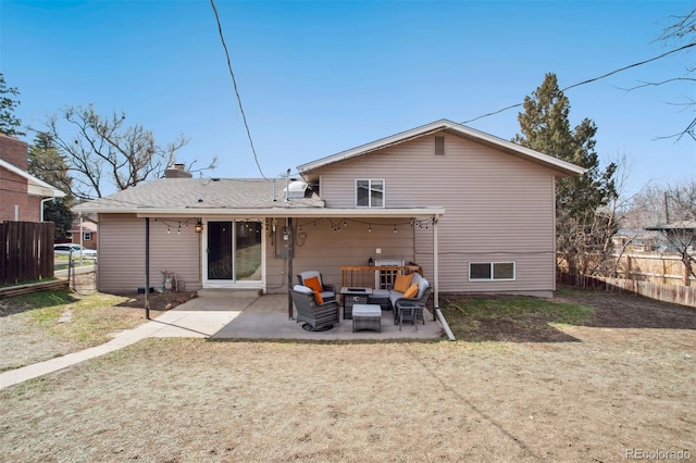 back of house with a chimney, fence, and a patio area