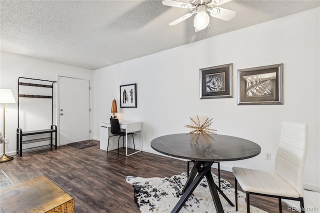 dining room with ceiling fan, a textured ceiling, and dark hardwood / wood-style flooring