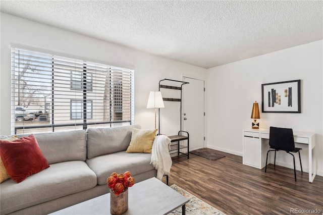 living room featuring dark hardwood / wood-style flooring and a textured ceiling