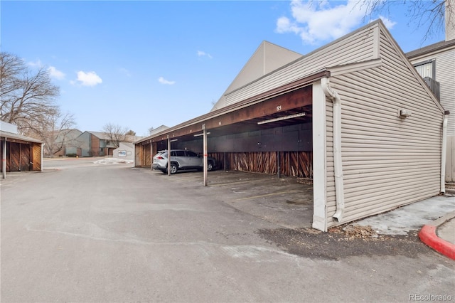 view of parking / parking lot featuring a carport