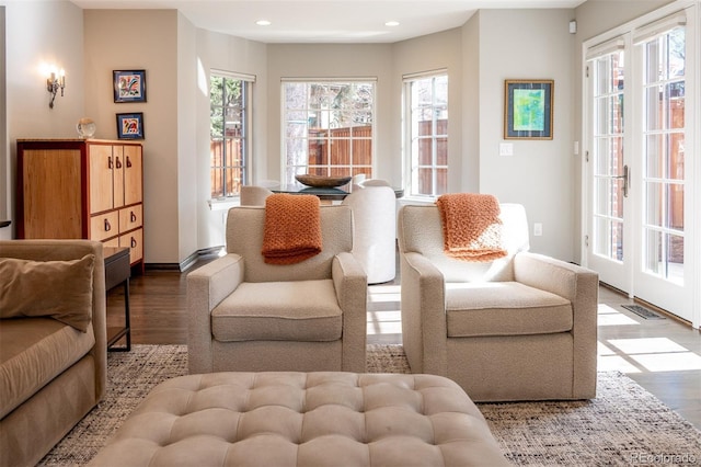 sitting room with baseboards, visible vents, wood finished floors, and recessed lighting