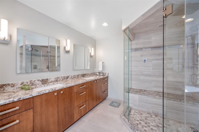 full bathroom with double vanity, recessed lighting, a sink, a shower stall, and tile patterned flooring