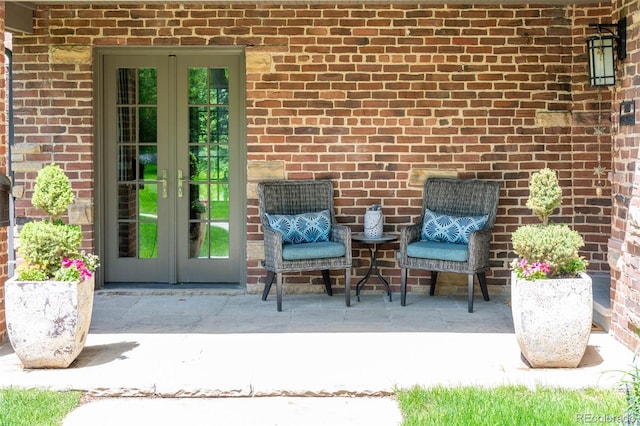 290 Dexter St, Denver, CO 80220 - doorway to property featuring french doors, a patio, and brick siding