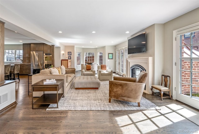290 Dexter St, Denver, CO 80220 - living room featuring a glass covered fireplace, wood finished floors, and recessed lighting