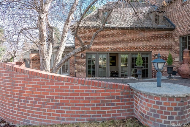 290 Dexter St, Denver, CO 80220 - rear view of house featuring brick siding and a patio