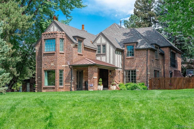 290 Dexter St, Denver, CO 80220 - view of front of property featuring a chimney, brick siding, and a standing seam roof