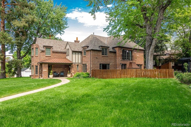 290 Dexter St, Denver, CO 80220 - rear view of house featuring a standing seam roof, brick siding, a chimney, and roof with shingles