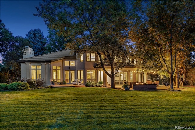 rear view of property with a yard and a patio area