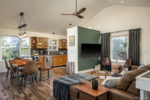 living room with lofted ceiling, a wealth of natural light, dark hardwood / wood-style floors, and ceiling fan